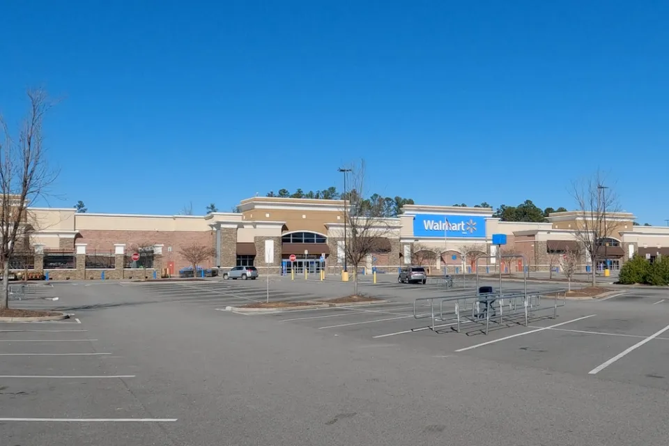 Large Walmart store with empty parking lot.
